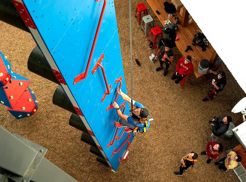 Climber scaling the warped wall obstacles from above